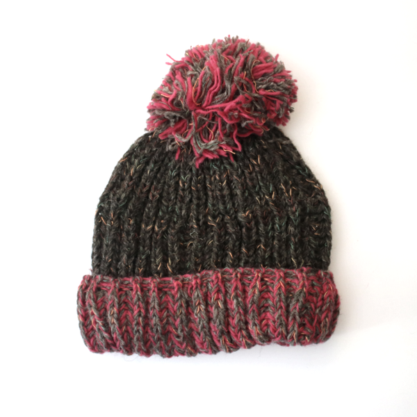 chunky knitted wool bobble hat with pink brim and pom pom
