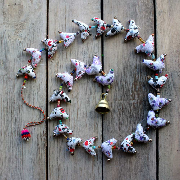 string of printed birds on white fabric