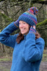 blue roll neck wool jumper and bobble hat