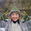 green matching wool bobble hat and wrist warmers