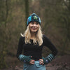 model wears matching women's felt flower teal beanie hat and wrist warmers