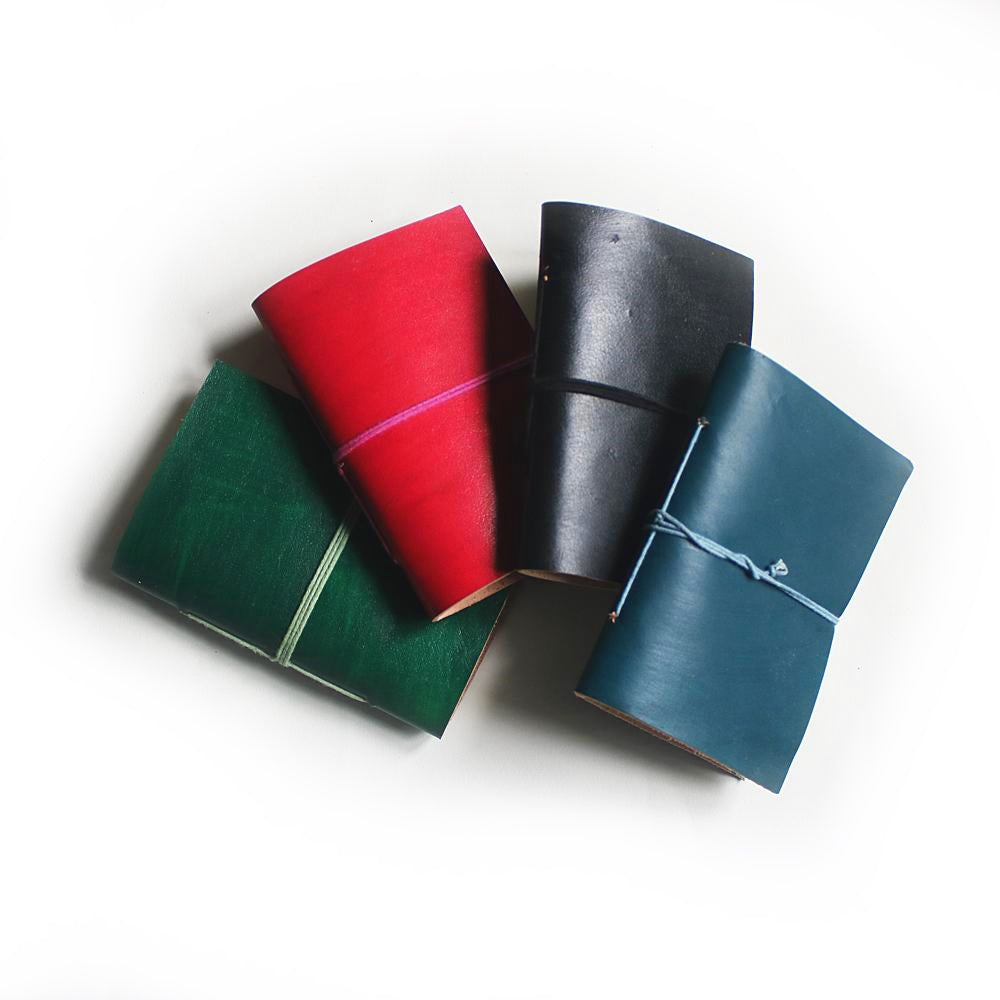 plain pocketbook leather journals in red, black, teal and green