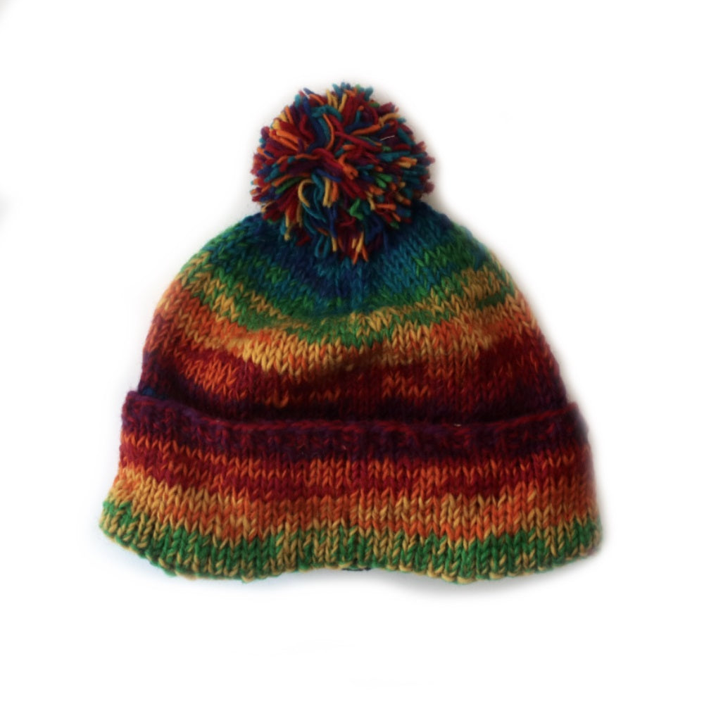 nordic knit wool bobble hat in rainbow colourful wool