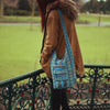 model wearing turquoise diamond shoulder bag 